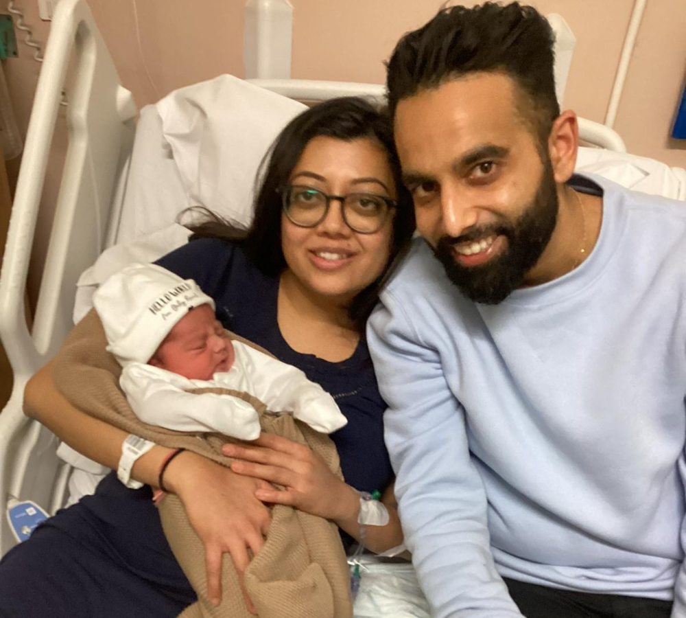 Mum and dad holding Baby boy Brahmbhatt, The Fifth baby to be born on New Year's Day.